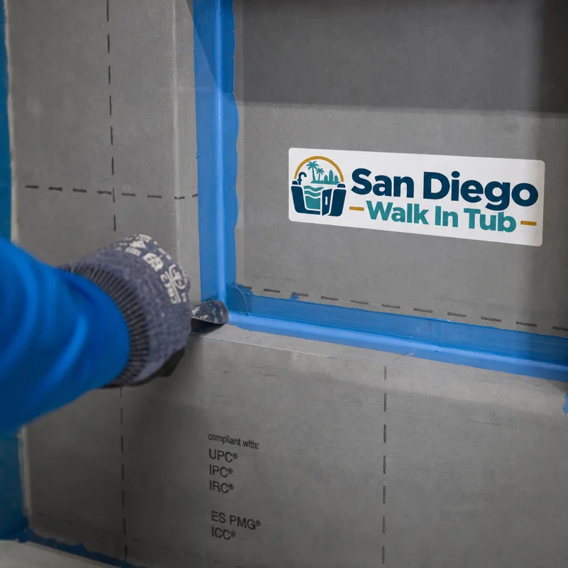 Waterproofing membrane with sealed seams around a shower niche and tile backer board